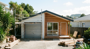 Garage being converted to living space showing old roller door and new cedar cladding